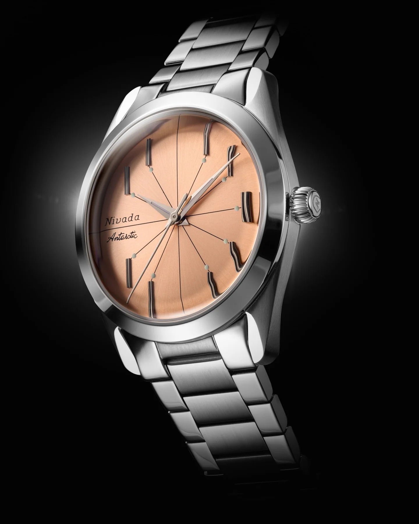 Silver watch with a rose gold face on a black background Nivada Grenchen Antarctic Spider