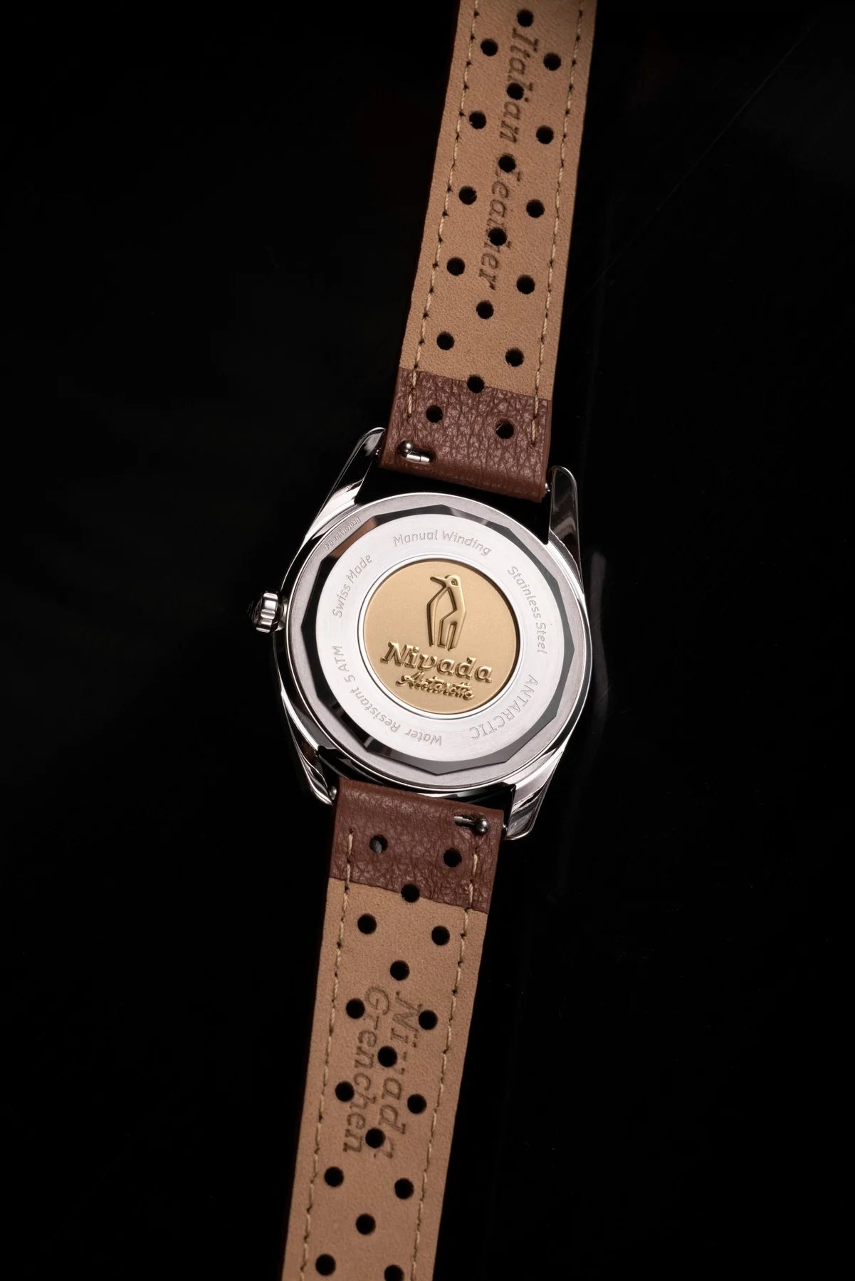 Watch with brown leather strap and visible brand logo on a black background Nivada Grenchen Antarctic Eggshell 