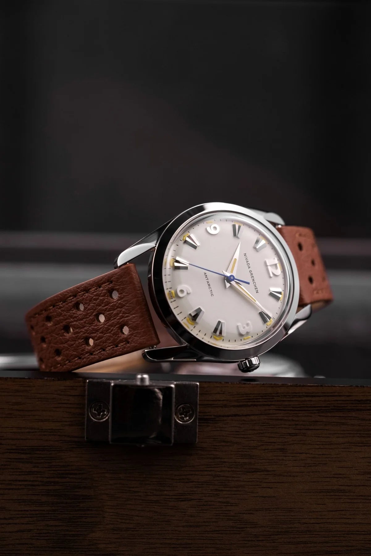 Wristwatch with brown leather strap on a dark background Nivada Grenchen Antarctic Eggshell Dial Beige Luminova